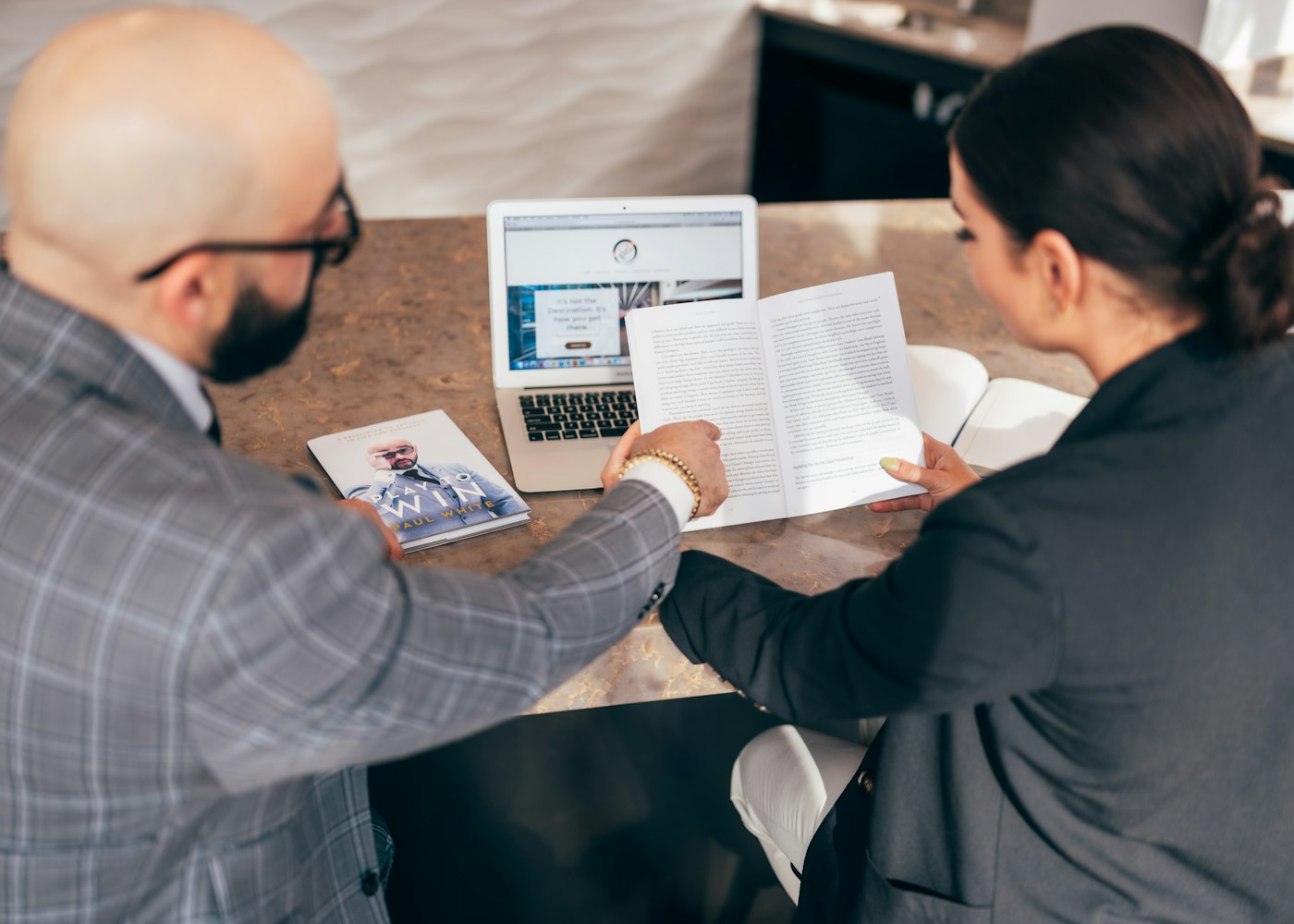 Two people reviewing mortgage options side by side